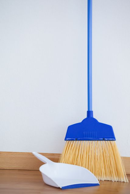 Dustpan and sweeping broom on wooden floor - Download Free Stock Photos Pikwizard.com