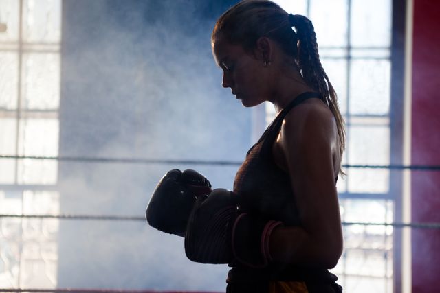 Determined woman standing in boxing ring - Download Free Stock Photos Pikwizard.com