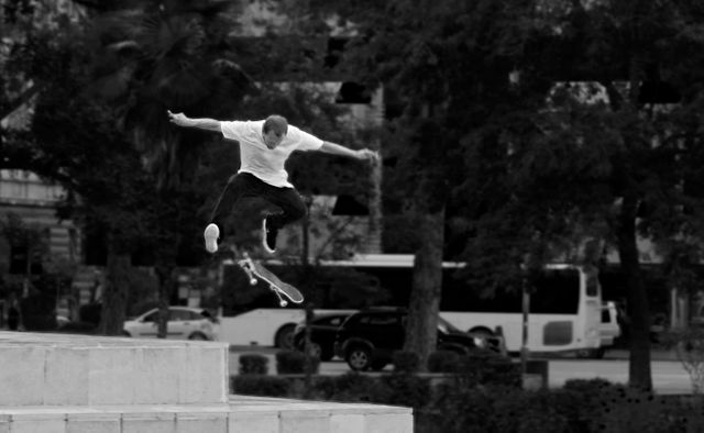 Man in White Shirt and Black Pants Playing Skateboard Near Green Tree during Daytime - Download Free Stock Photos Pikwizard.com