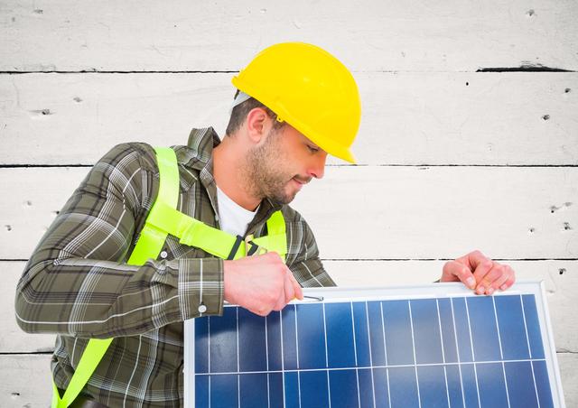 Technician installingsolar panel against wooden plank background - Download Free Stock Photos Pikwizard.com