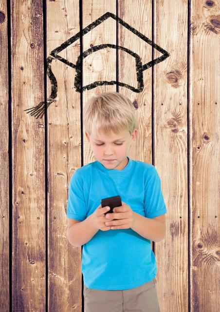 Boy using mobile phone with graduation hat on wooden background - Download Free Stock Photos Pikwizard.com