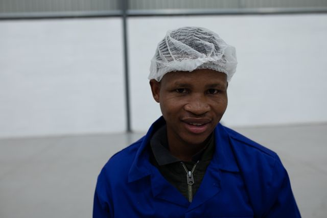 Portrait of a worker dressed in blue with protective cap - Download Free Stock Photos Pikwizard.com