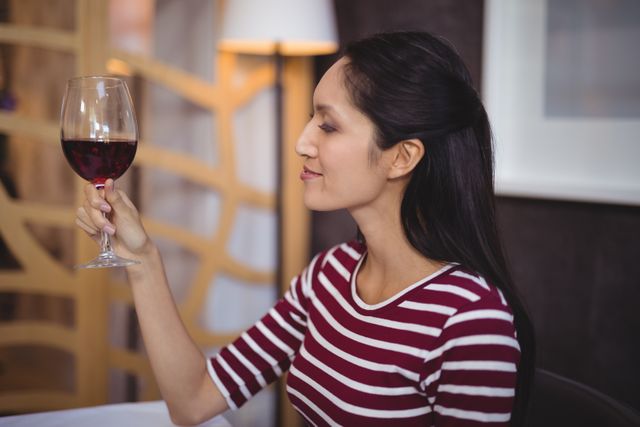 Woman having a glass of red wine - Download Free Stock Photos Pikwizard.com