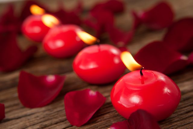 Red wax candles surrounded with rose petals - Download Free Stock Photos Pikwizard.com