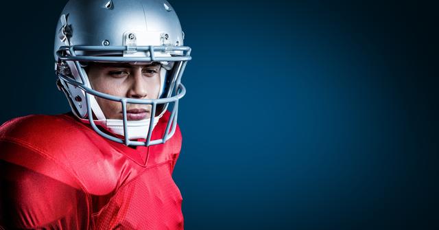 American football player standing against blue background - Download Free Stock Photos Pikwizard.com