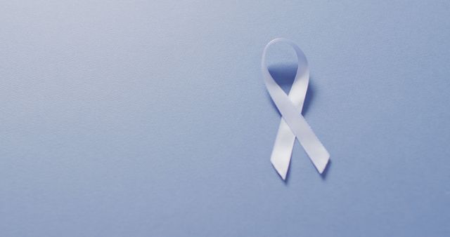 Image of pale blue prostate cancer ribbon on blue background - Download Free Stock Photos Pikwizard.com
