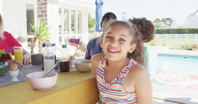 Image of biracial girl with diverse family spending time together and having dinner outside - Download Free Stock Photos Pikwizard.com