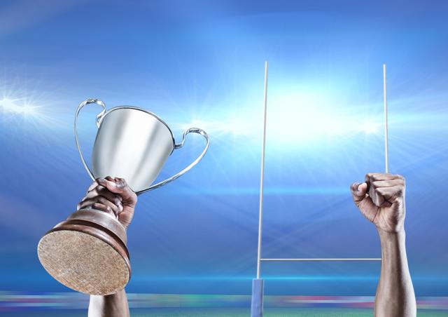 Player lifting trophy against goal post in background - Download Free Stock Photos Pikwizard.com
