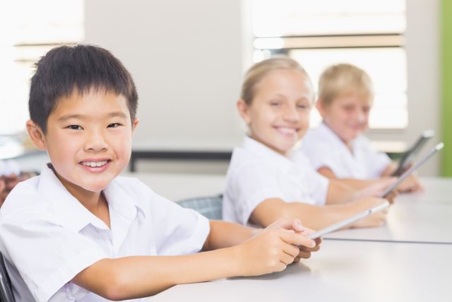 Kids using digital tablet in classroom - Download Free Stock Photos Pikwizard.com