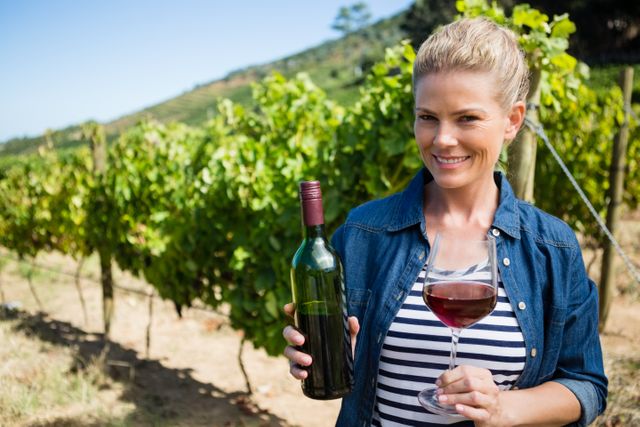Portrait of female vintner examining wine in vineyard - Download Free Stock Photos Pikwizard.com