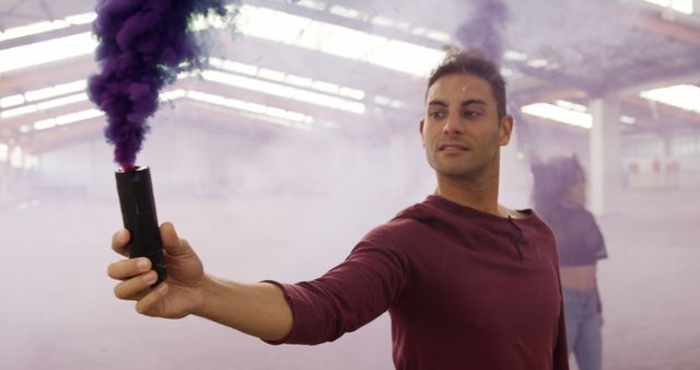 Diverse male and female dancers with coloured smoke flares in abandoned warehouse - Download Free Stock Photos Pikwizard.com