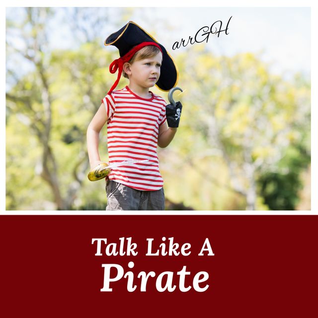 Digital image of cute caucasian boy playing pirate in park with talk like a pirate text, copy space. Parodic holiday, romanticized view of golden age of piracy, talk exclusively in pirate lingo.