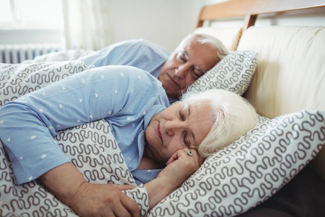 Senior couple sleeping on bed - Download Free Stock Photos Pikwizard.com
