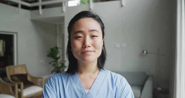 Portrait of happy asian female nurse at work in hospital, smiling to camera. medicine, health and healthcare services.