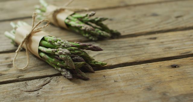 Image of two fresh asparagus bundles with copy space on wooden background - Download Free Stock Photos Pikwizard.com