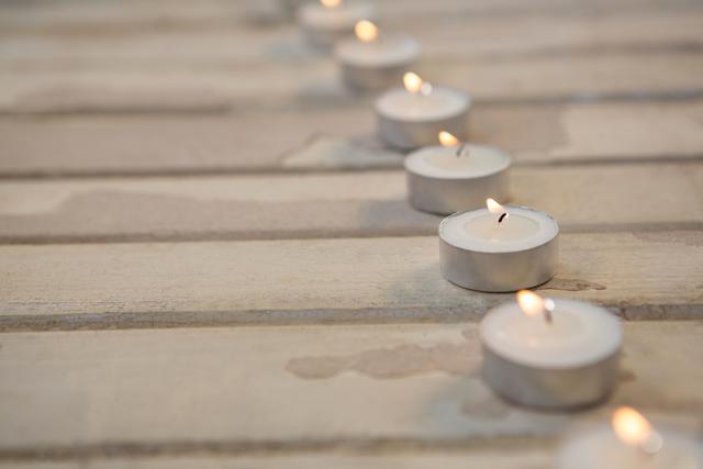 Candles burning on wooden plank - Download Free Stock Photos Pikwizard.com