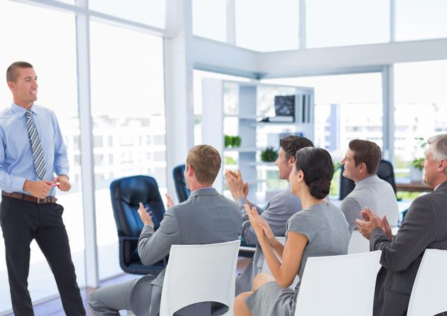 Business executives clapping hands while colleague presentation in conference room - Download Free Stock Photos Pikwizard.com
