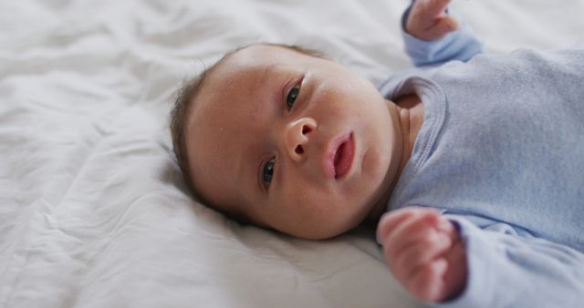 Image of caucasian newborn baby lying on bed - Download Free Stock Photos Pikwizard.com