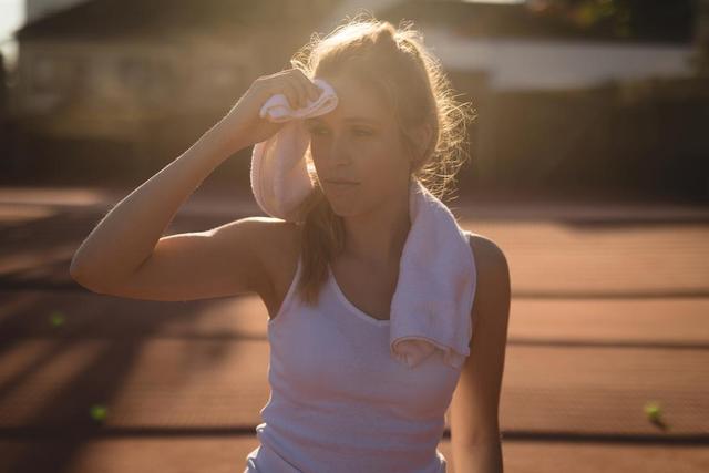 Tennis player wiping sweat with napkin - Download Free Stock Photos Pikwizard.com