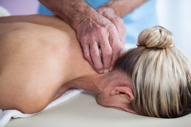 Woman receiving neck massage from physiotherapist - Download Free Stock Photos Pikwizard.com