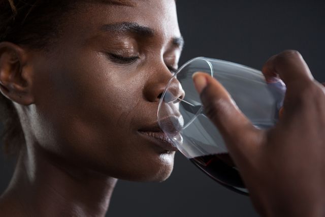 Androgynous man drinking wine from glass - Download Free Stock Photos Pikwizard.com