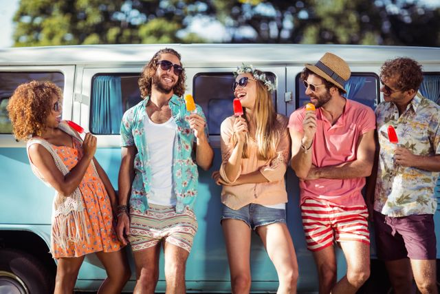 Group of happy friends standing with ice lolly in front of camper van - Download Free Stock Photos Pikwizard.com