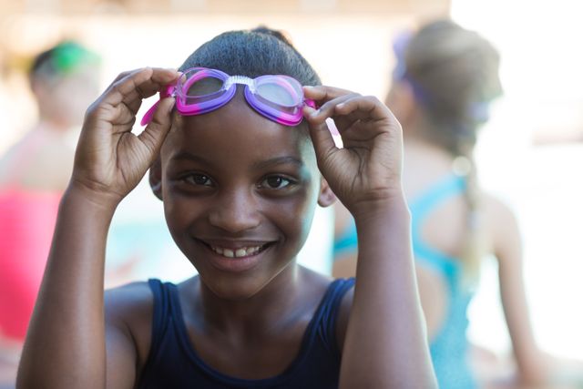 Portrait of smiling girl holding swimming goggles - Download Free Stock Photos Pikwizard.com