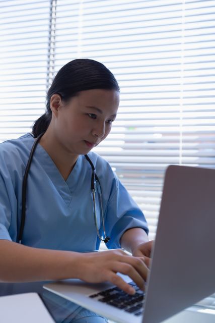 Female surgeon using laptop at desk in clinic at hospital - Download Free Stock Photos Pikwizard.com