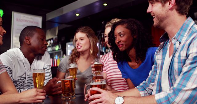 A diverse group of young adults enjoys a social gathering at a bar ...