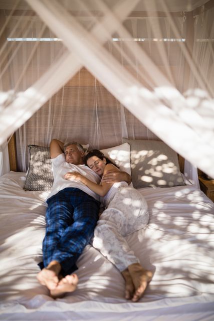 Couple relaxing in canopy bed - Download Free Stock Photos Pikwizard.com
