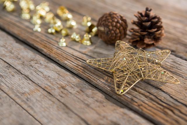 Christmas bells, pine cone and star on wooden plank - Download Free Stock Photos Pikwizard.com