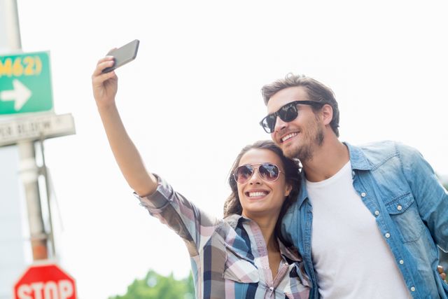 Young couple in sunglasses taking a selfie - Download Free Stock Photos Pikwizard.com