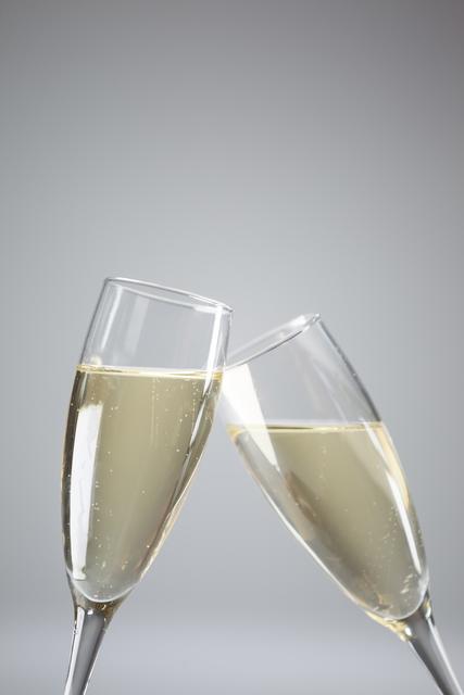 Two champagne flutes on white background - Download Free Stock Photos Pikwizard.com