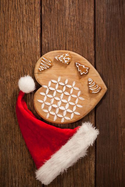 Various ginger bread on wooden board decorated with santa hat - Download Free Stock Photos Pikwizard.com