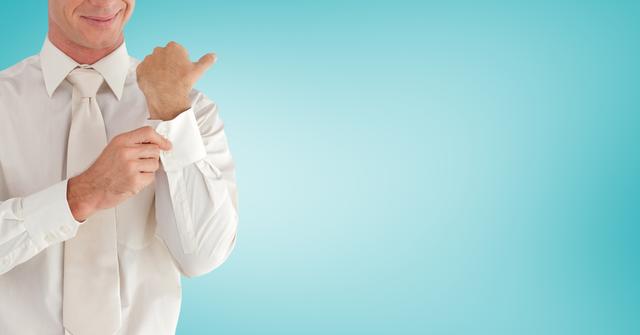 Man adjusting his cufflings against sky blue background - Download Free Stock Photos Pikwizard.com