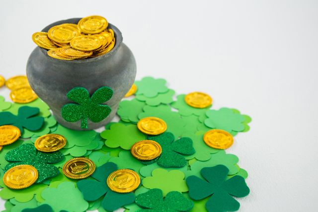 St. Patricks Day shamrocks and pot filled with chocolate gold coins - Download Free Stock Photos Pikwizard.com
