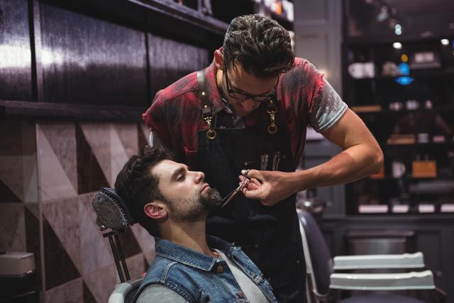 Man getting his beard trimmed with scissor - Download Free Stock Photos Pikwizard.com