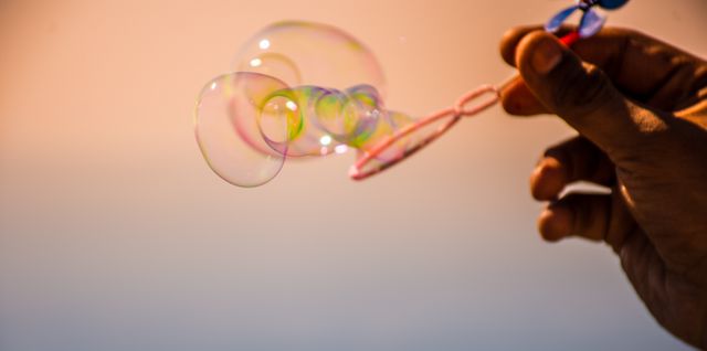 a person holding a soap bubble - Download Free Stock Photos Pikwizard.com