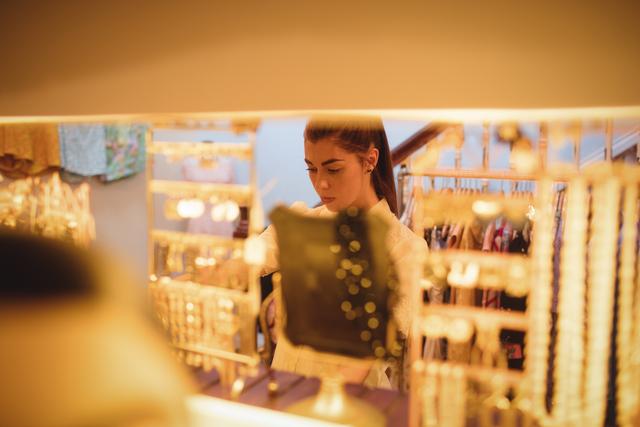 Woman selecting a jewellery in boutique store