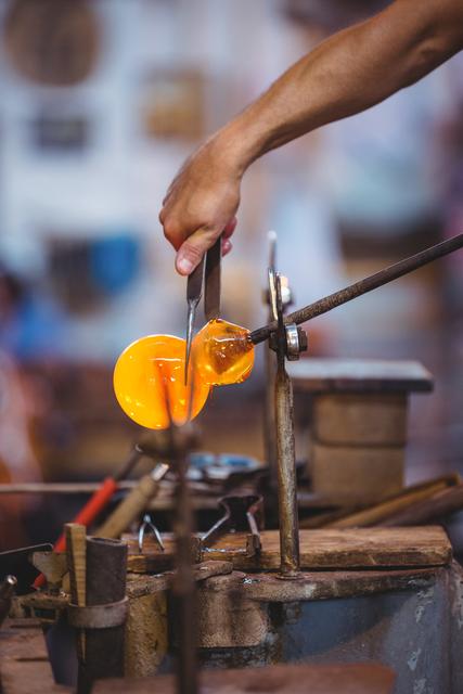 Glassblower shaping a molten glass - Download Free Stock Photos Pikwizard.com