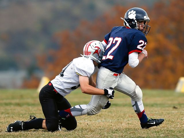 Football Player in White Trying to Stop a Player in Blue - Download Free Stock Photos Pikwizard.com