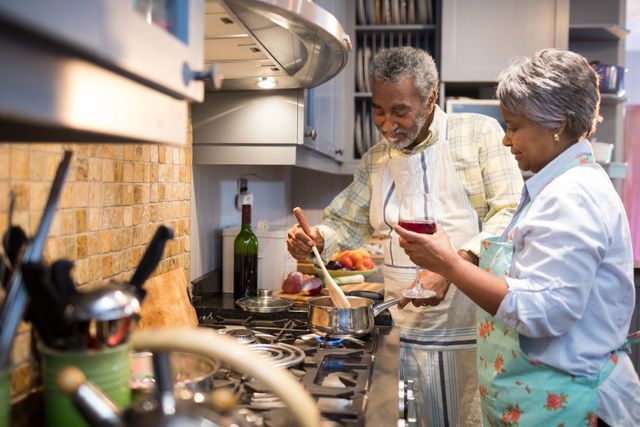 Senior couple preparing food in kitchen - Download Free Stock Photos Pikwizard.com