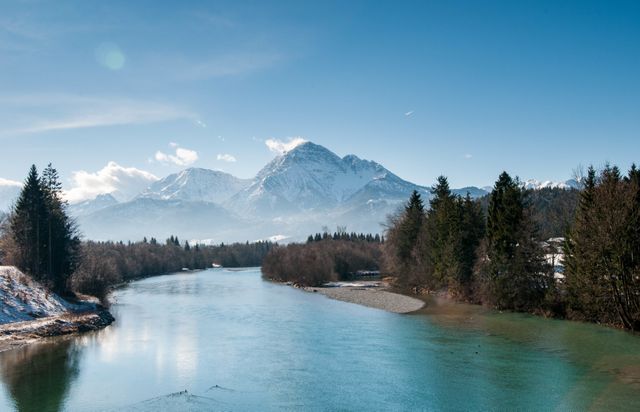 a river with snow capped mountains in the background - Download Free Stock Photos Pikwizard.com