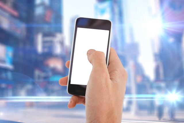 Composite image of hand holding smartphone with city background 