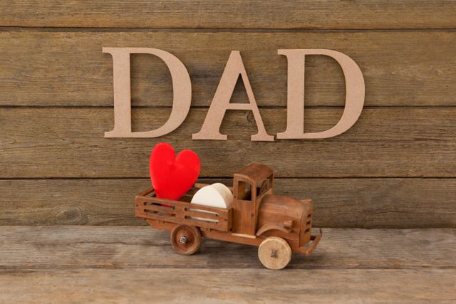 Dad text by heart shape in toy truck on table - Download Free Stock Photos Pikwizard.com