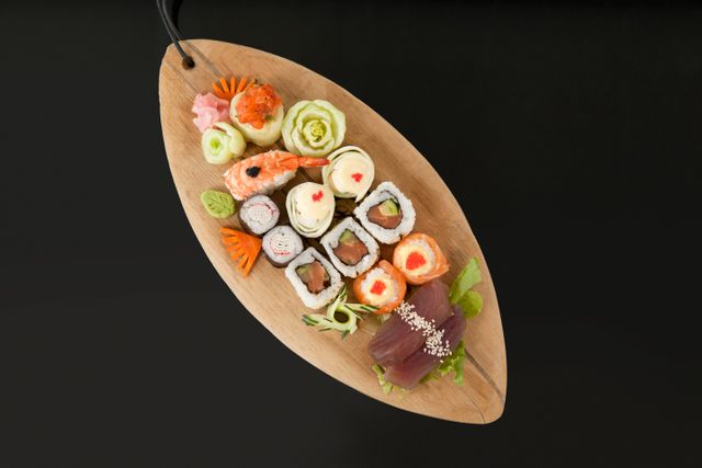 Assorted sushi set served in wooden boat plate - Download Free Stock Photos Pikwizard.com
