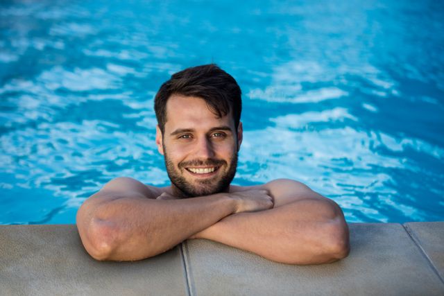 Portrait of young man relaxing in the pool - Download Free Stock Photos Pikwizard.com