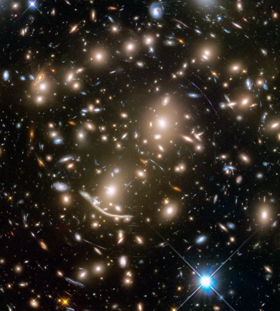 Much like the eclectic group of space rebels in the upcoming film Guardians of the Galaxy Vol. 2, NASA’s Hubble Space Telescope has some amazing superpowers, specifically when it comes to observing innumerable galaxies flung across time and space.  A stunning example is a galaxy cluster called Abell 370 that contains an astounding assortment of several hundred galaxies tied together by the mutual pull of gravity. That’s a lot of galaxies to be guarding, and just in this one cluster!  Read more: <a href="https://go.nasa.gov/2paAitl" rel="nofollow">go.nasa.gov/2paAitl</a>  Photo caption: Galaxy cluster Abell 370 contains several hundred galaxies tied together by the mutual pull of gravity. Photographed in a combination of visible and near-infrared light, the brightest and largest galaxies are the yellow-white, massive, elliptical galaxies containing many hundreds of billions of stars each. Spiral galaxies have younger populations of stars and are bluish. Mysterious-looking arcs of blue light are distorted images of remote galaxies behind the cluster. The cluster acts as a huge lens in space that magnifies and stretches images of background galaxies like a funhouse mirror.  Photo Credit: NASA, ESA, and J. Lotz and the HFF Team (STScI)  <b><a href="http://www.nasa.gov/audience/formedia/features/MP_Photo_Guidelines.html" rel="nofollow">NASA image use policy.</a></b>  <b><a href="http://www.nasa.gov/centers/goddard/home/index.html" rel="nofollow">NASA Goddard Space Flight Center</a></b> enables NASA’s mission through four scientific endeavors: Earth Science, Heliophysics, Solar System Exploration, and Astrophysics. Goddard plays a leading role in NASA’s accomplishments by contributing compelling scientific knowledge to advance the Agency’s mission.  <b>Follow us on <a href="http://twitter.com/NASAGoddardPix" rel="nofollow">Twitter</a></b>  <b>Like us on <a href="http://www.facebook.com/pages/Greenbelt-MD/NASA-Goddard/395013845897?ref=tsd" rel="nofollow">Facebook</a></b>  <b>Find us on <a href="http://instagrid.me/nasagoddard/?vm=grid" rel="nofollow">Instagram</a></b>     