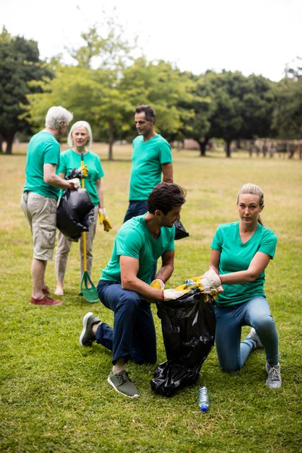 Team of volunteers picking up litter - Download Free Stock Photos Pikwizard.com
