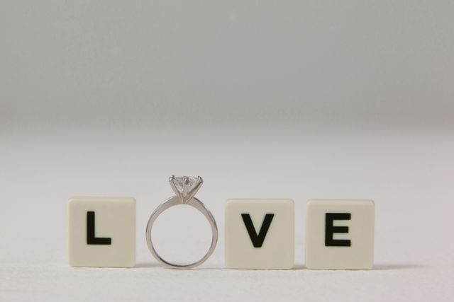 Diamond ring between white blocks displaying love message - Download Free Stock Photos Pikwizard.com